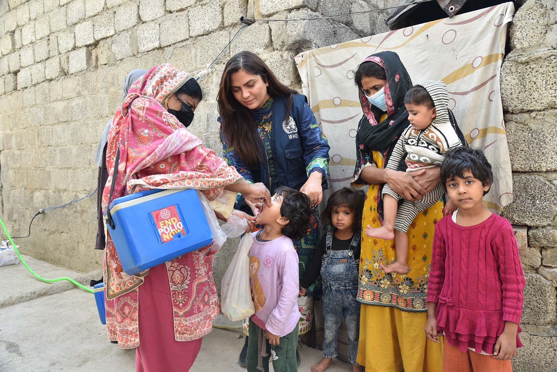 WHO staff and a polio vaccinator during a vaccination campaign in Pakistan