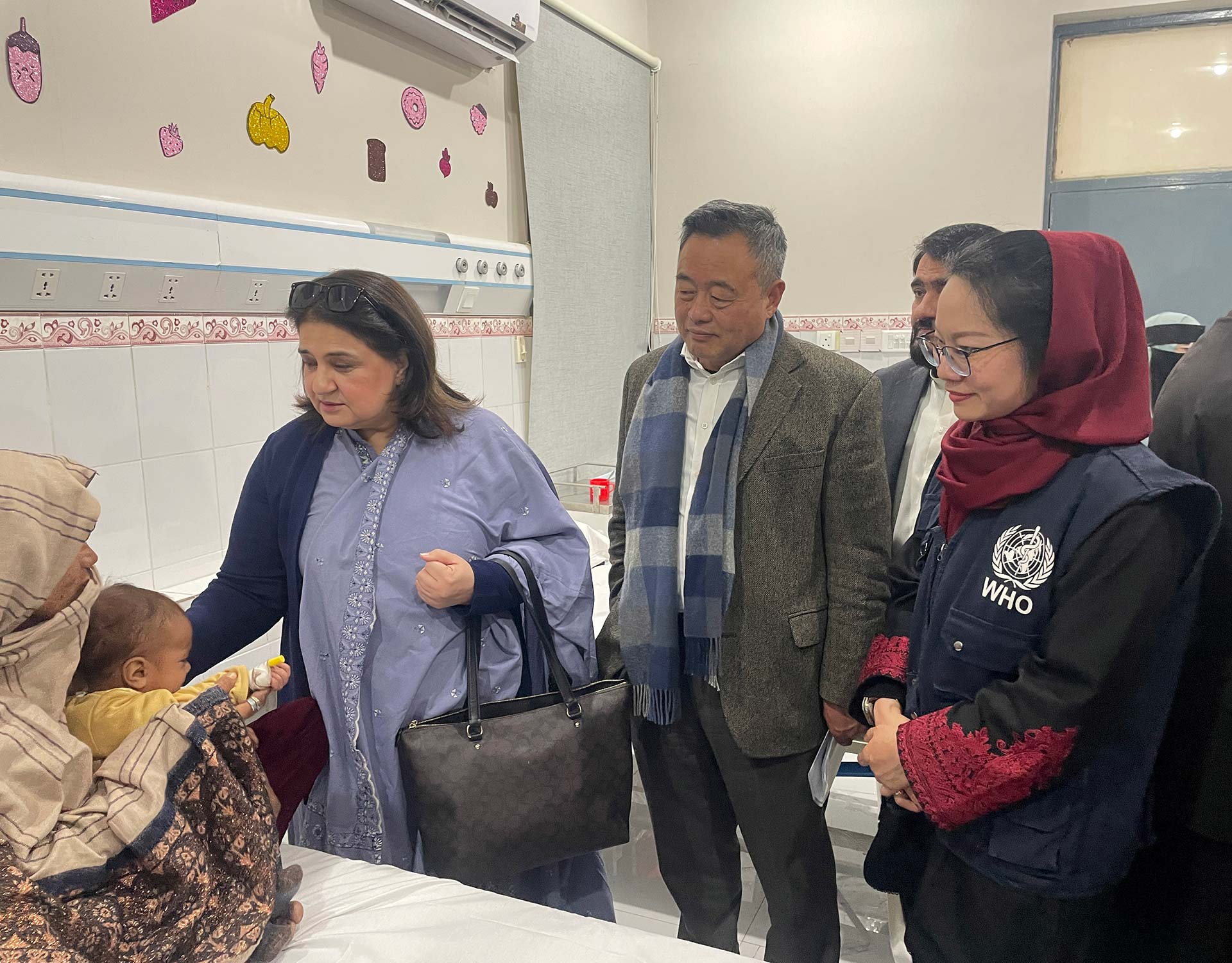 WHO staff and a polio vaccinator during a vaccination campaign in Pakistan